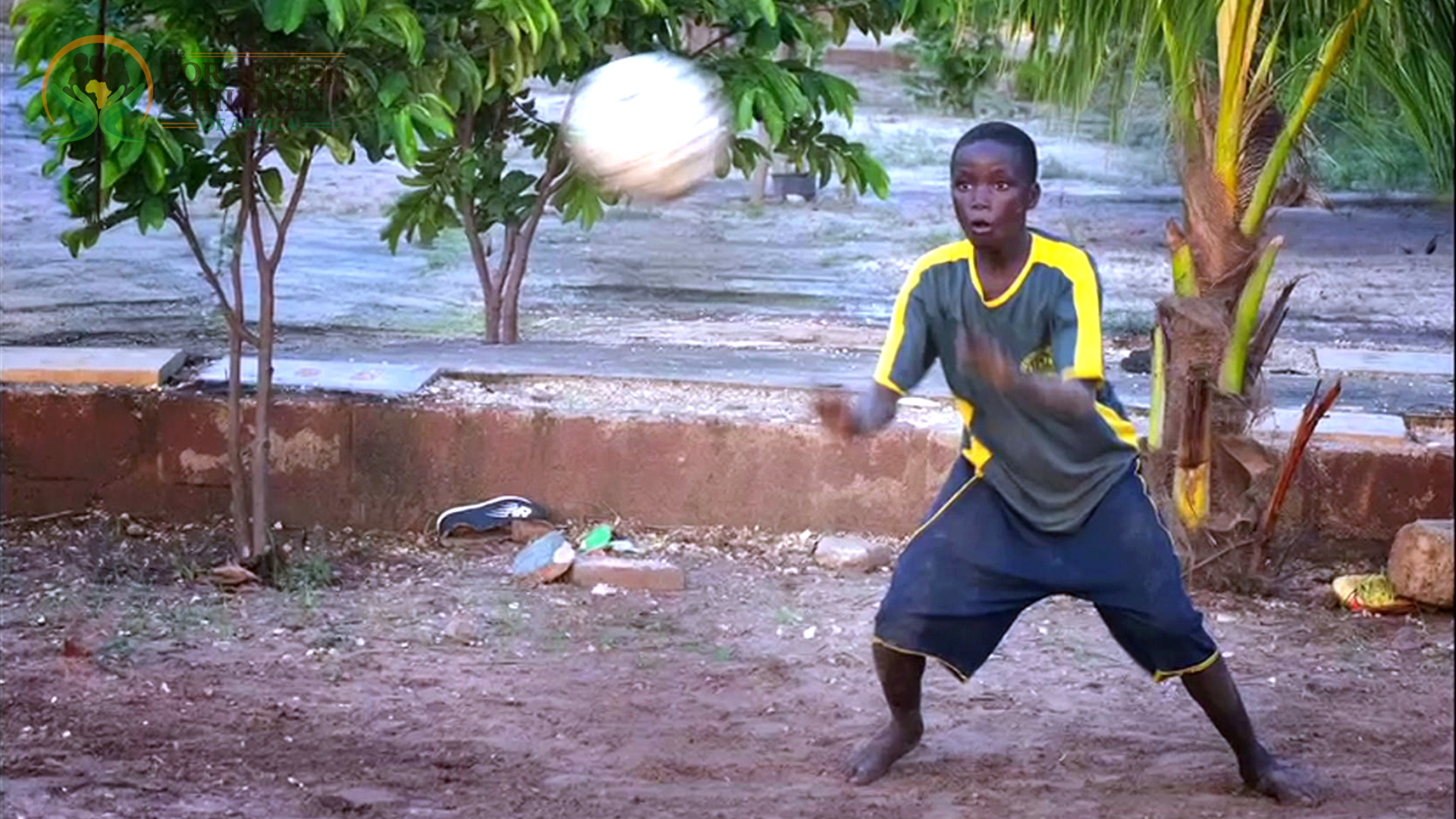 A boy playing soccer outdoors.