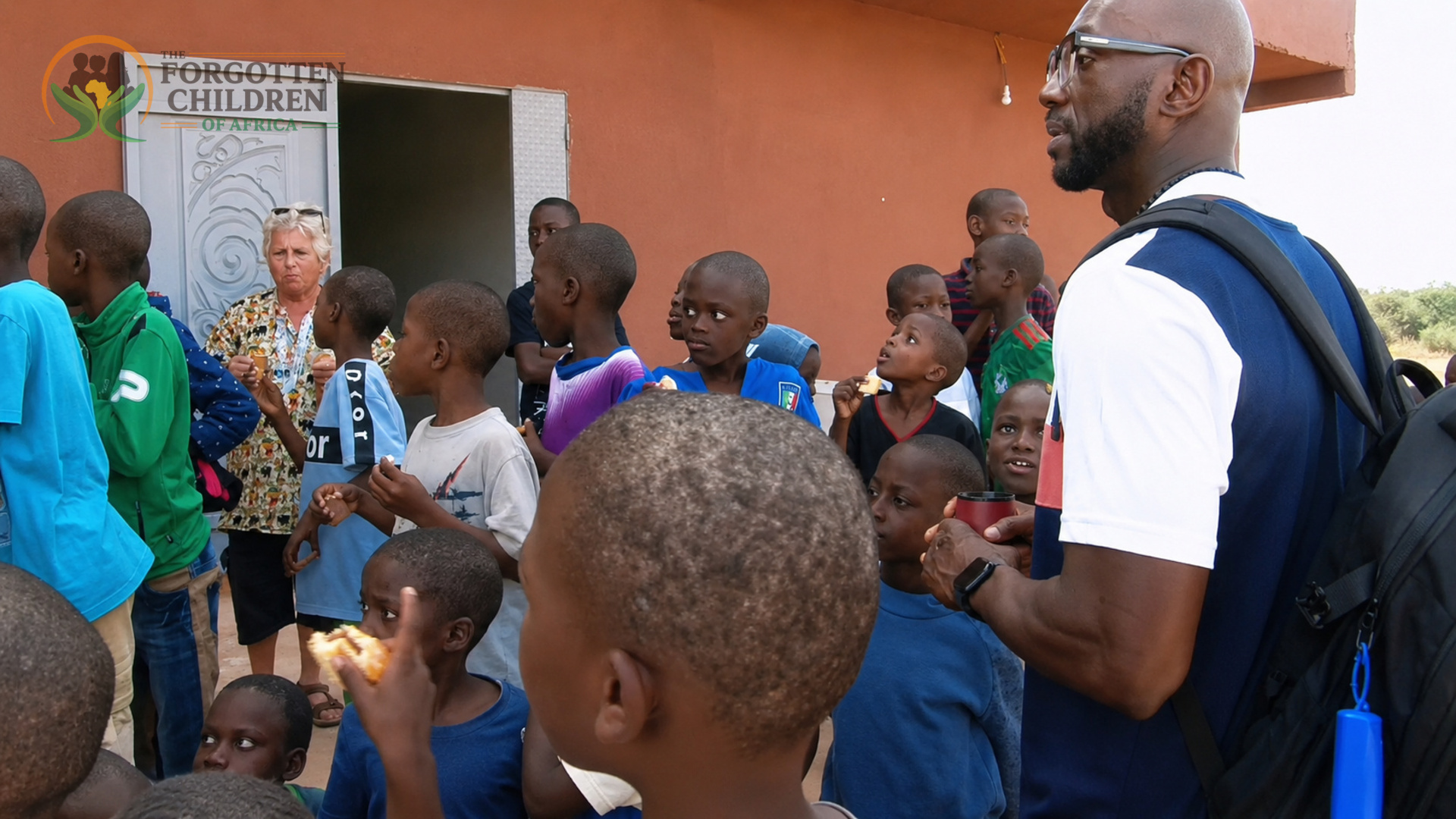 Children listening to the program director