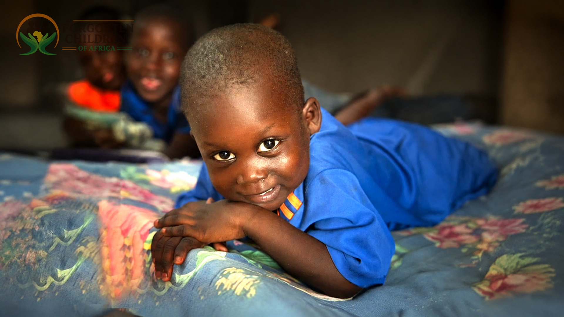Smiling boy resting on bed