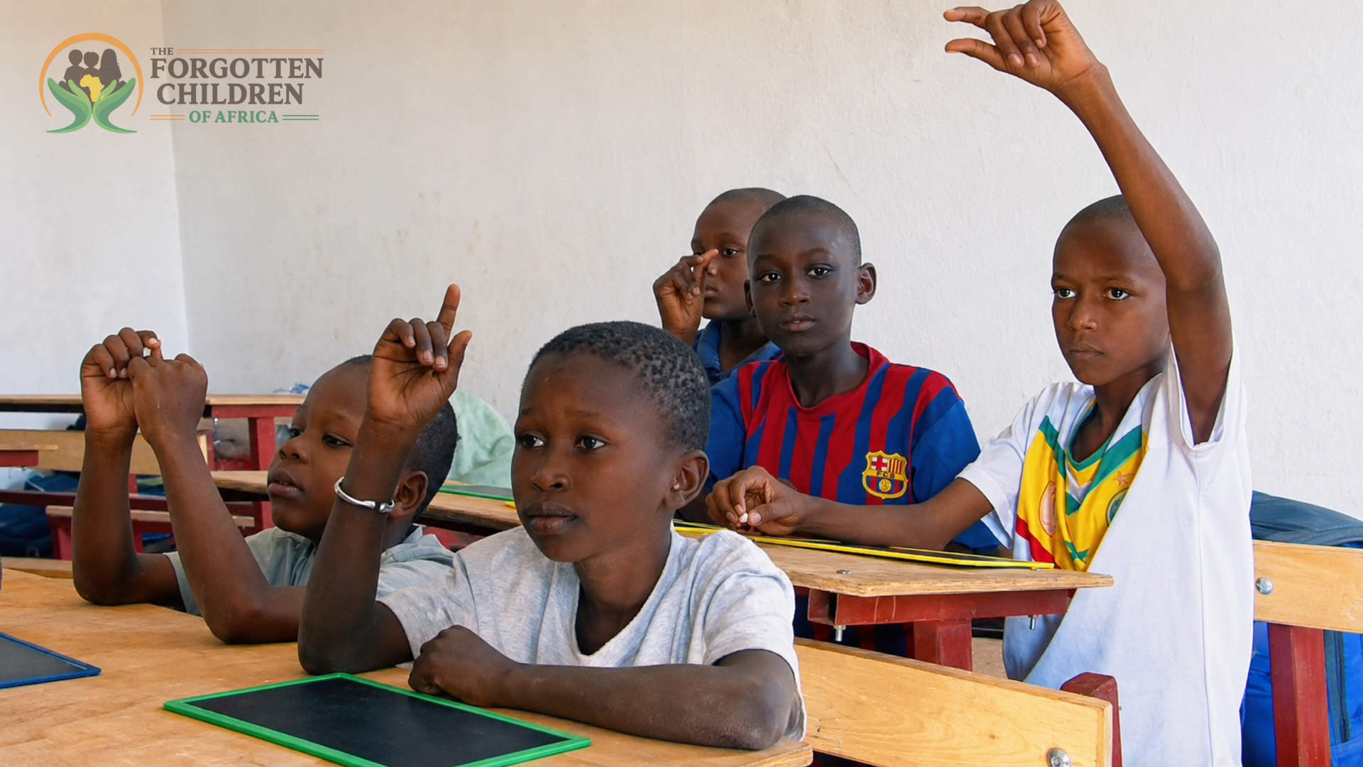 Students raising their hands in class at the boarding school