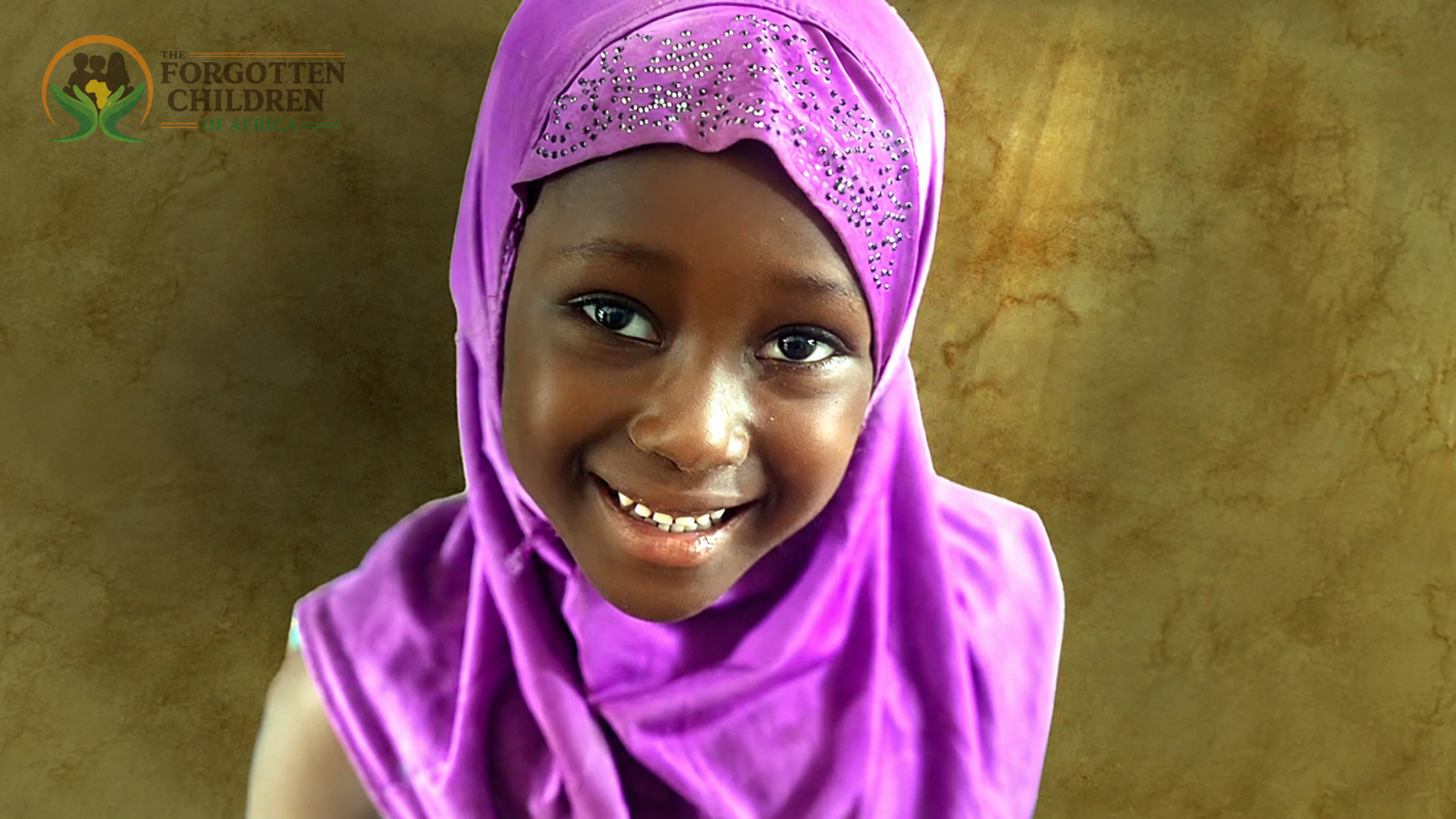 Two smiling girls in headscarves
